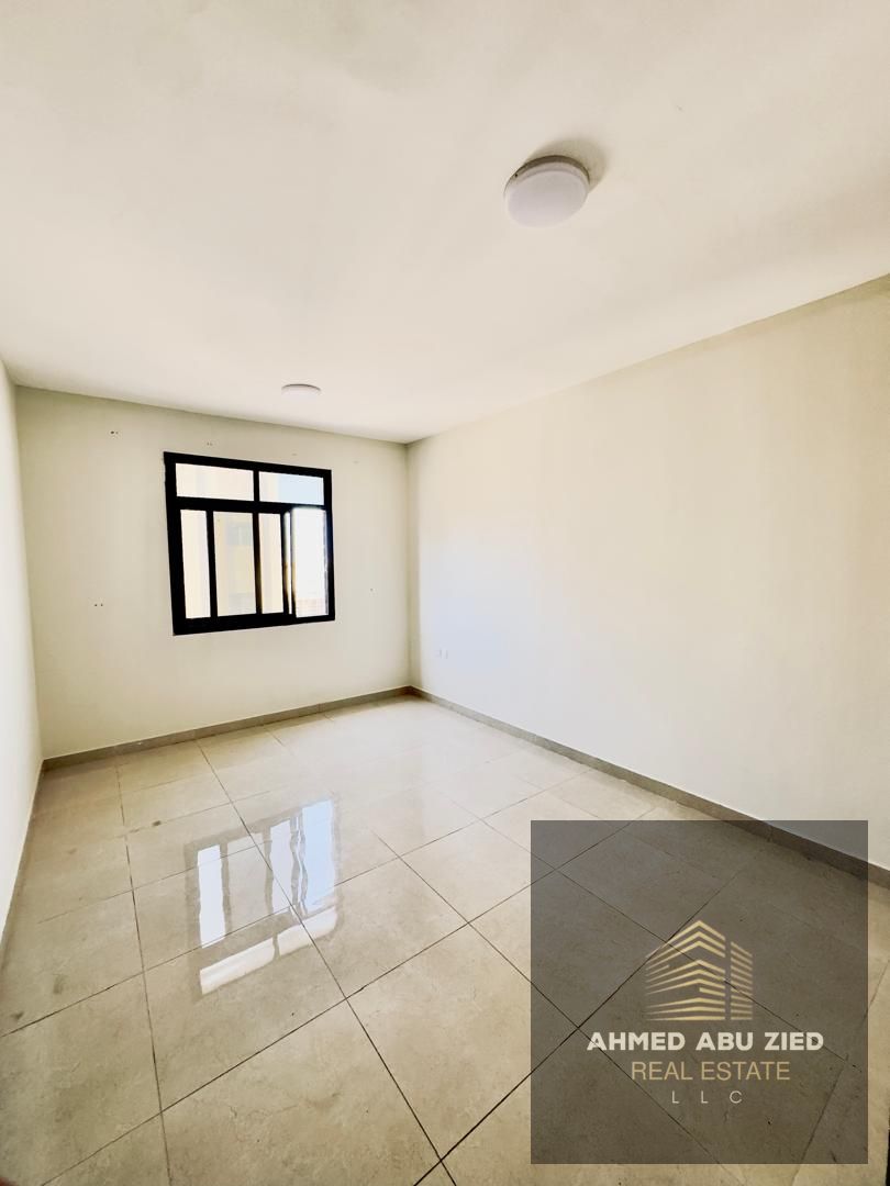 Cheapest large 1BHK in Al Jurf 3. Open-view balcony, central AC, spacious layout, bathroom, close to Dubai & Sharjah exit.