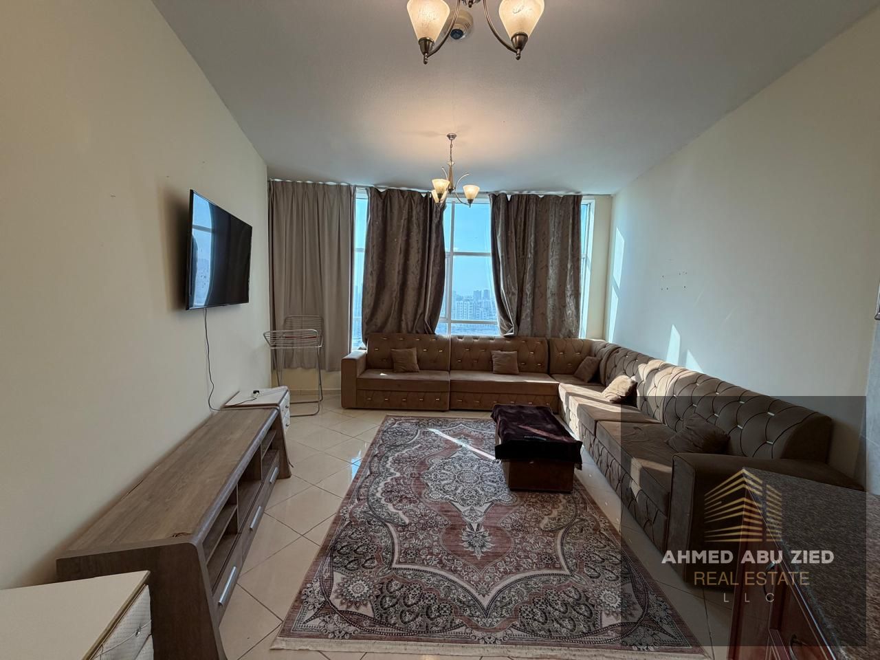 Furnished 1BR + living room for annual rent in Ajman, Orient Towers, Mina Street. Fully furnished, balcony, 2 bathrooms, central AC, opposite the Fish