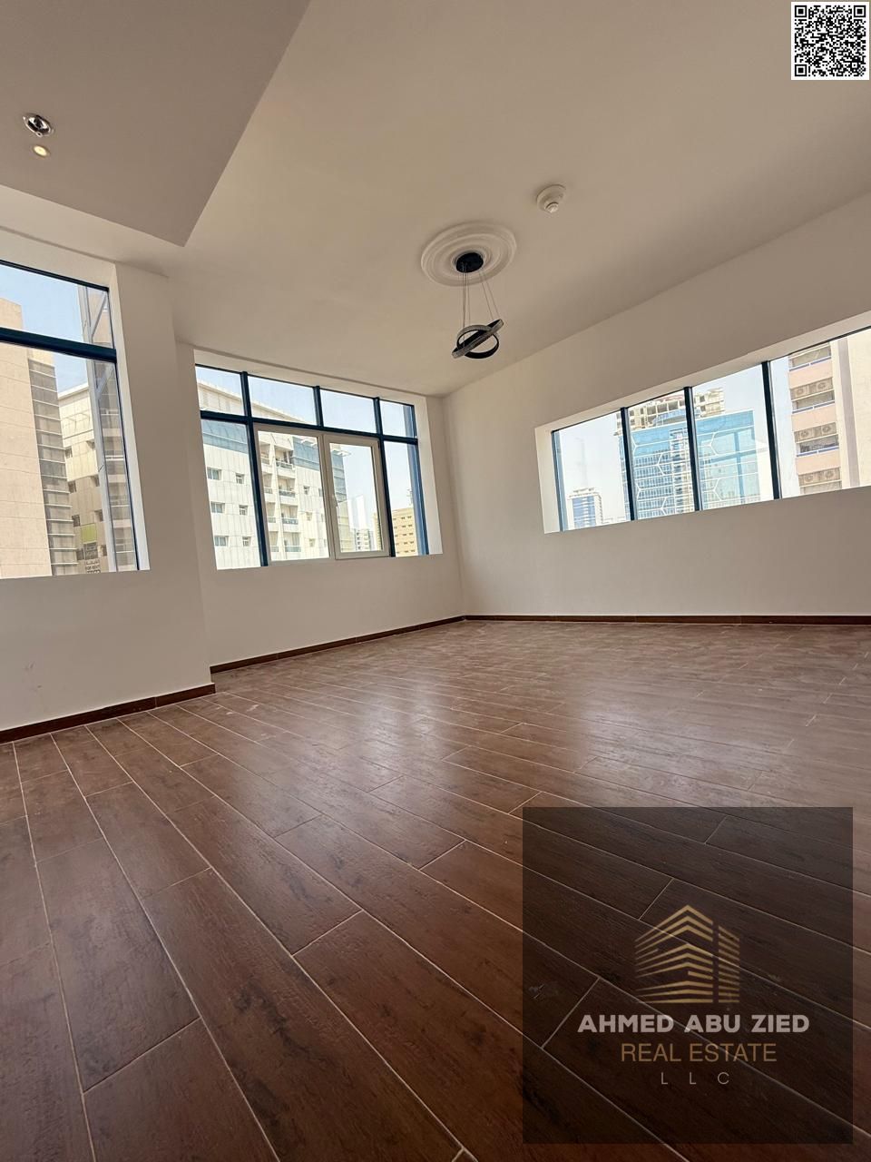 Upscale and luxurious two-bedroom apartment with a large living room, spacious kitchen, central air conditioning, balcony with open views, and two bat