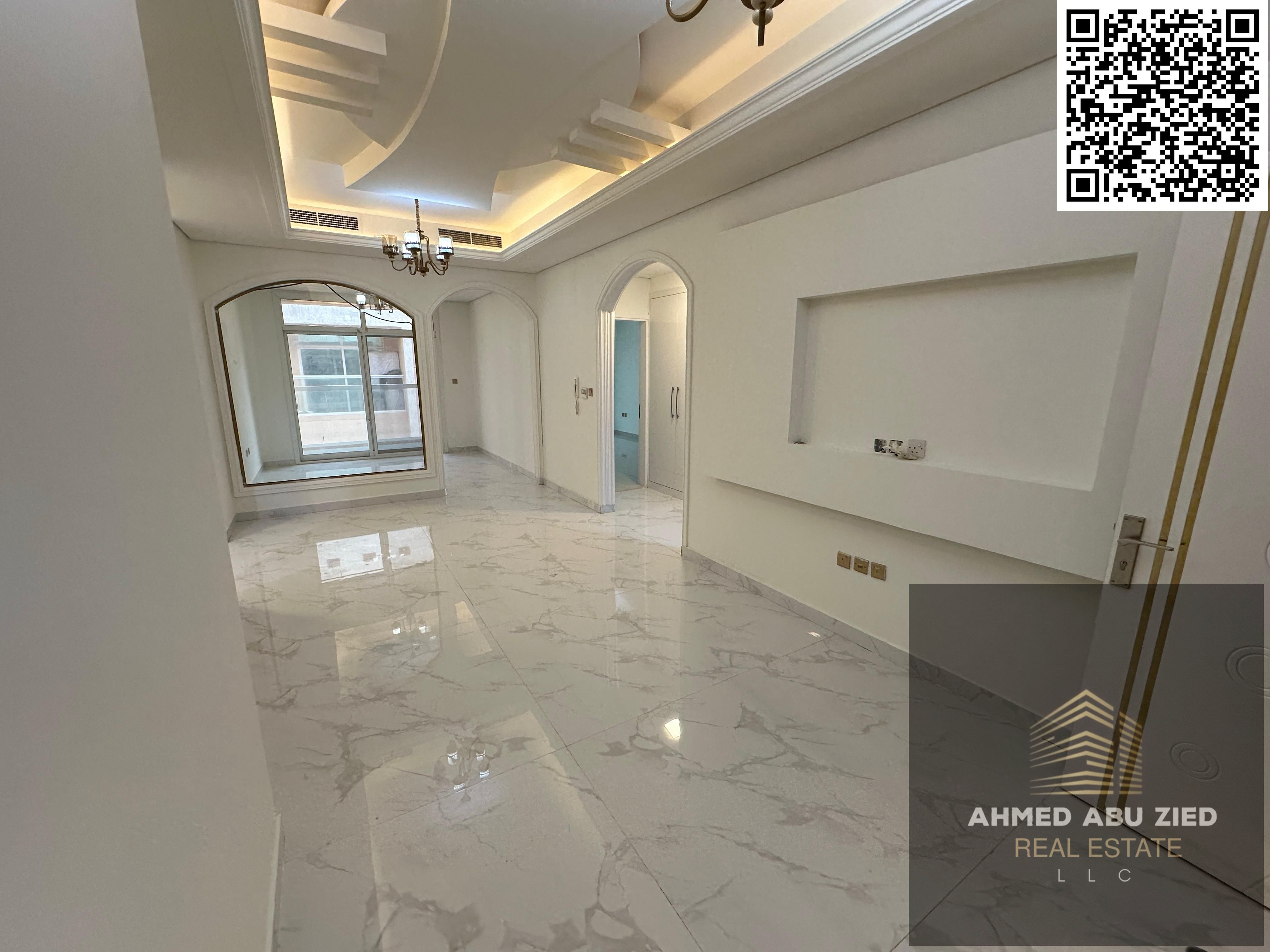 Upscale and luxurious two-bedroom apartment with a large living room, traditional Arabic majlis, balcony with open views, built-in wardrobes, gym, and