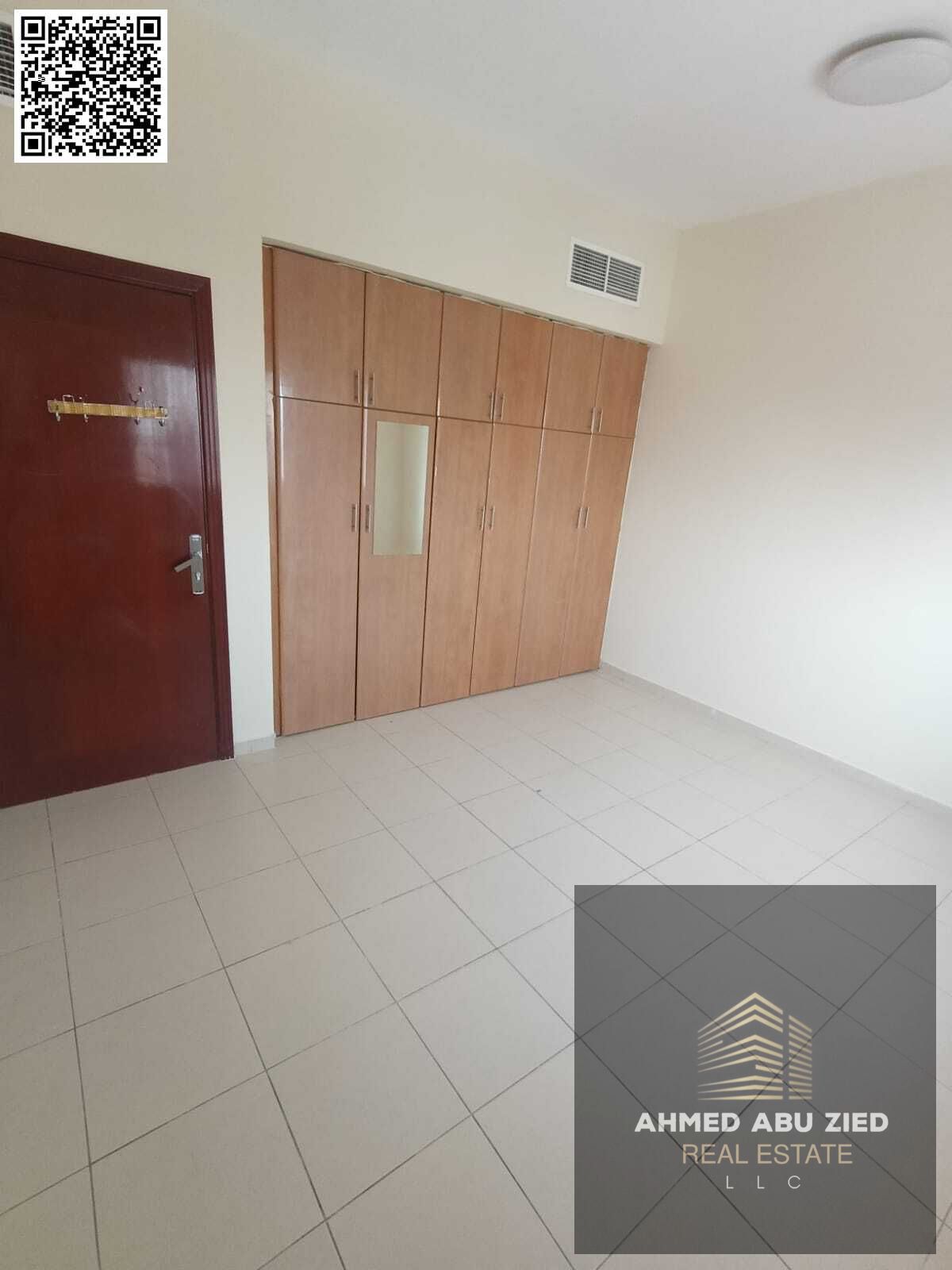 For annual rent in Ajman Al Nuaimiya 1 near Al Hikma School, a spacious two-bedroom apartment with a living room, two bathrooms, built-in wardrobes, a