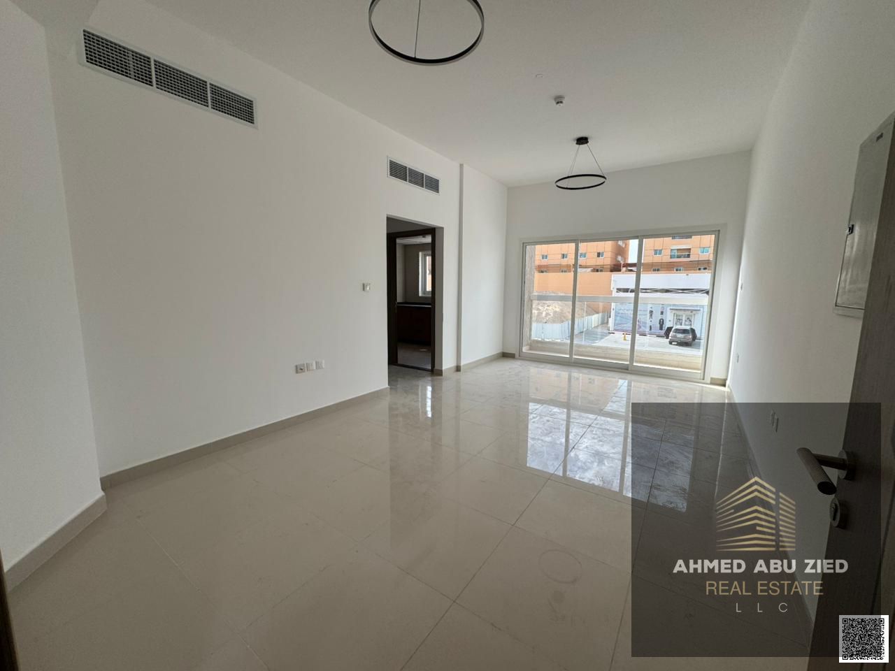 Premium 1-bedroom apartment for annual rent in Ajman, master bedroom, large balcony, central AC, open view, latest décor and lighting, lively area.