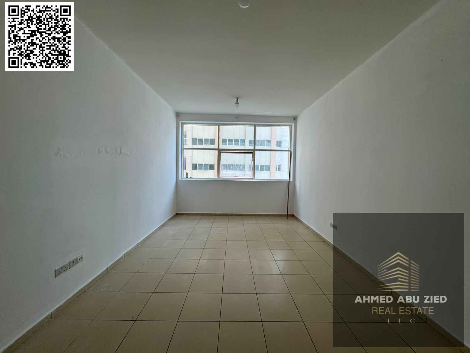 The most luxurious studio apartment for annual rent in Ajman One Towers, featuring a semi-separate kitchen, one bathroom, built-in wardrobes, and a ga