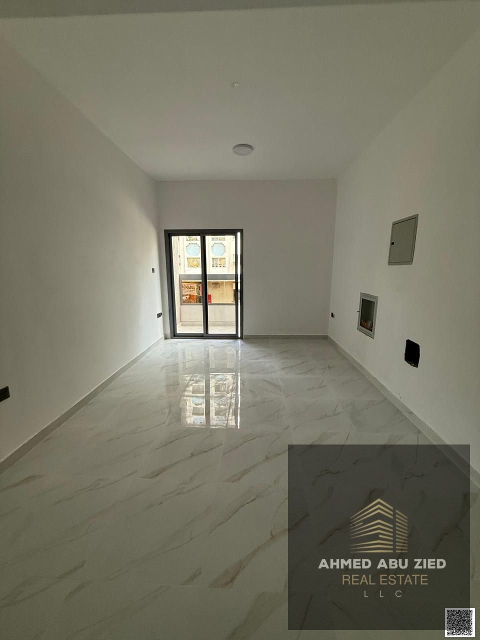 Annual 1BR hall for rent in Ajman: master bedroom, balcony with open view, central AC, modern finishes, near services, easy access to Sharjah & Dubai.