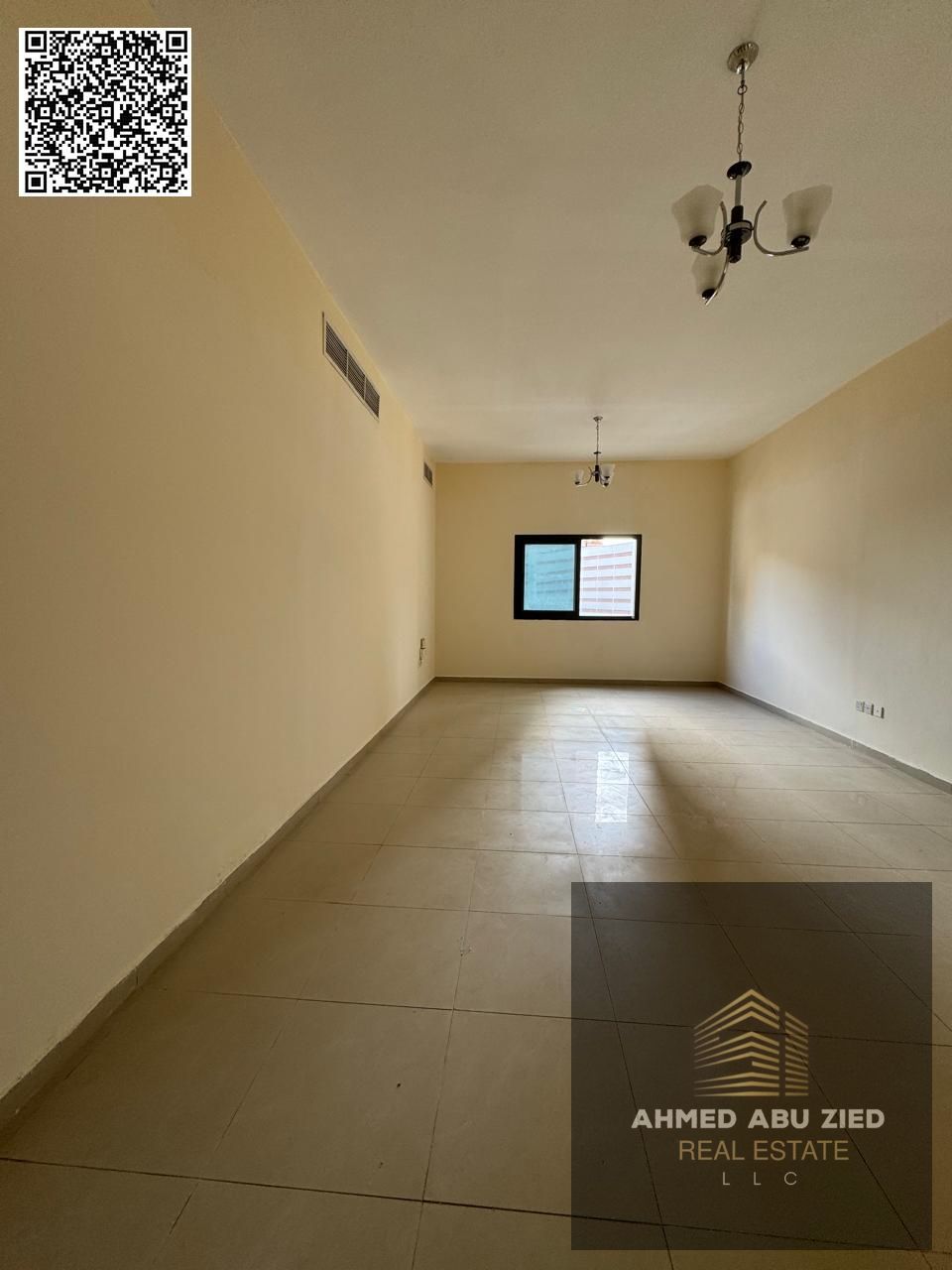 For annual rent in Ajman, a two-bedroom apartment with a living room, two bathrooms, a balcony with an open view, spacious layout, and central air con
