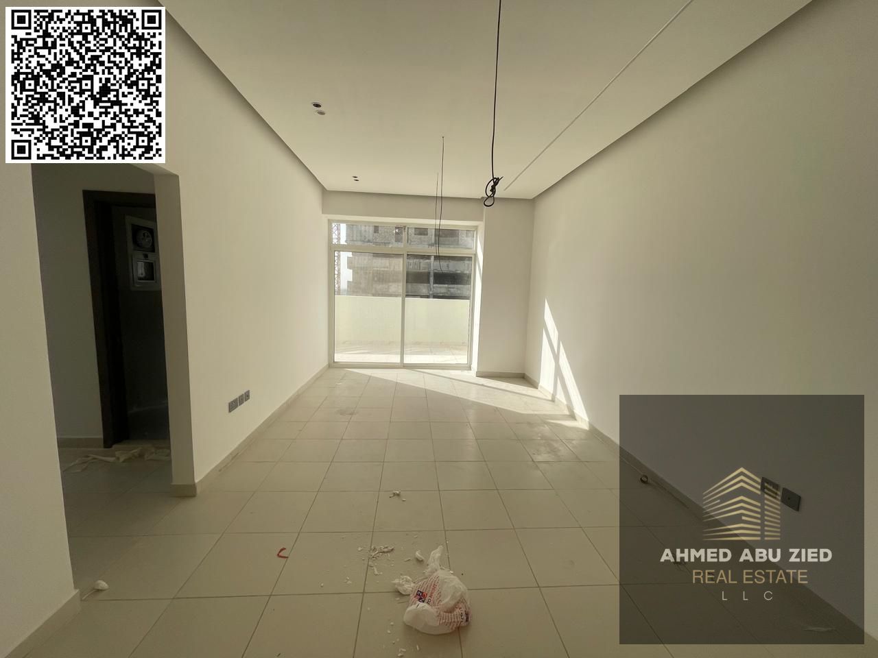For annual rent in Ajman, a new building offers a two-bedroom apartment with a living room, three bathrooms, two balconies with open views, a spacious