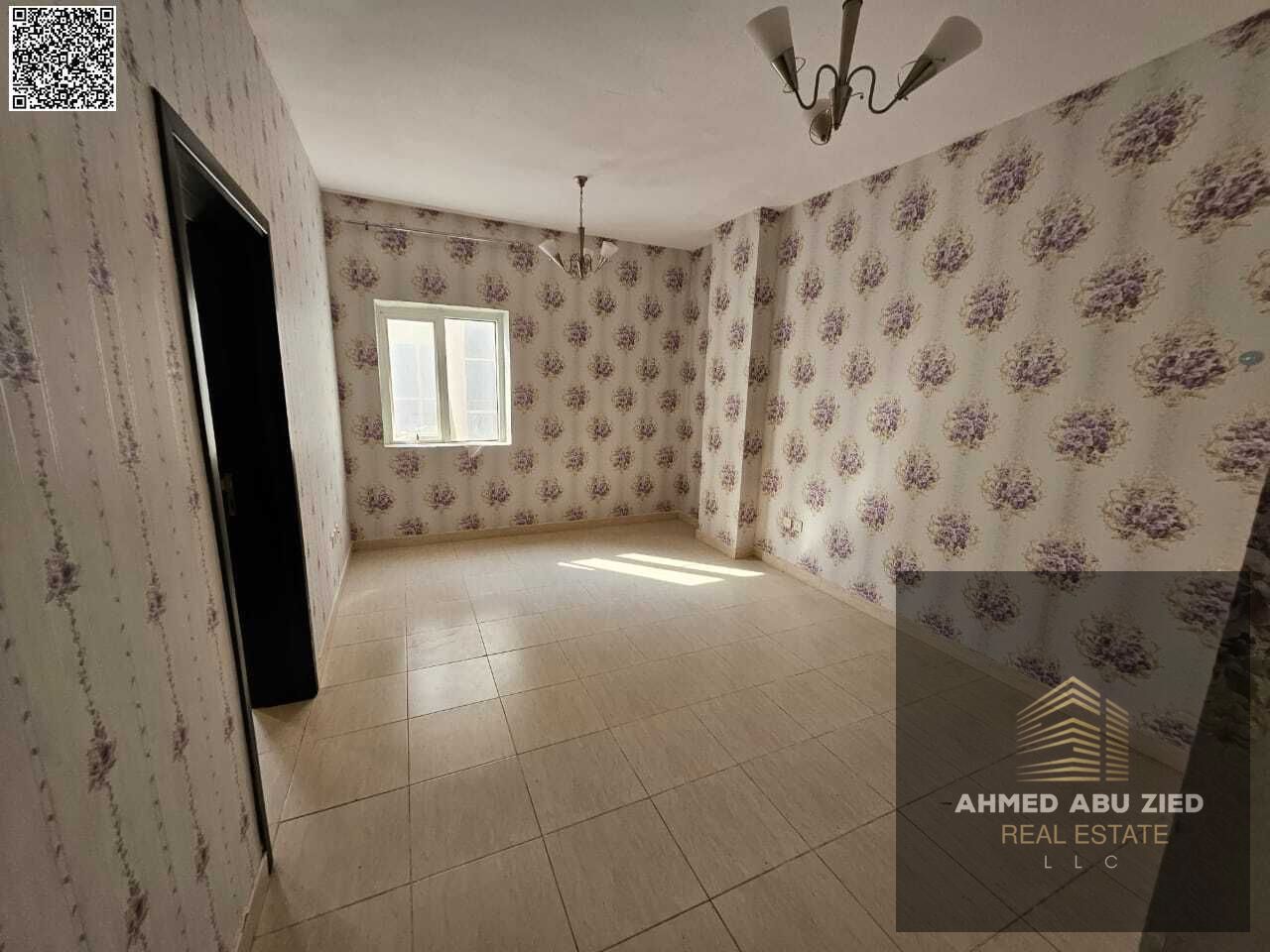 Annual rent: beautiful 1BR in Al Yasmin – hall, central AC, 2 baths, hotel-style finish, spacious, easy payment plan, prime location near Dubai exit.
