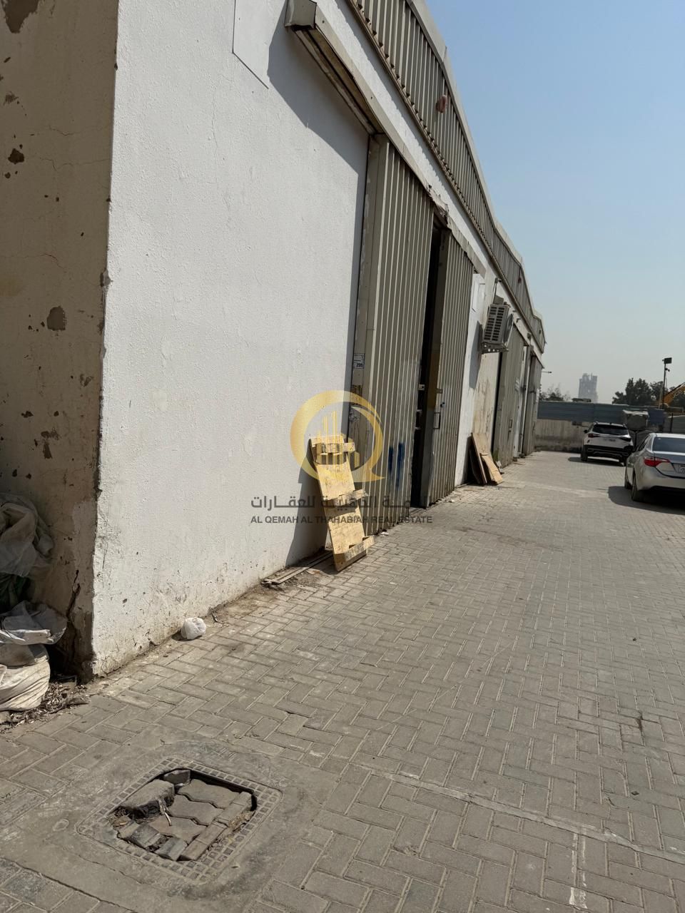For sale: a developed land in Al-Sajaa Industrial Area, consisting of a commercial-residential building, warehouses, and workers' accommodation with e