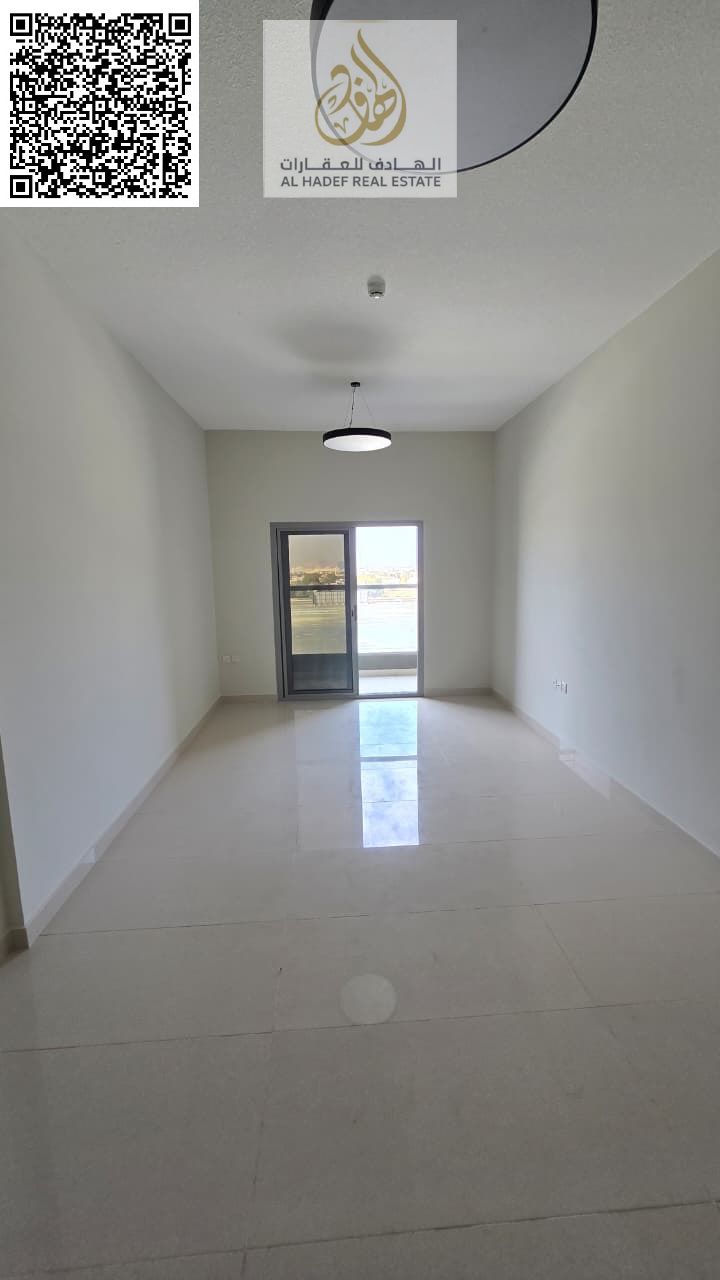 A detached one-bedroom apartment with a living room, two bathrooms, a balcony, built-in wardrobes, and parking. Located in a prime location in Ajman T