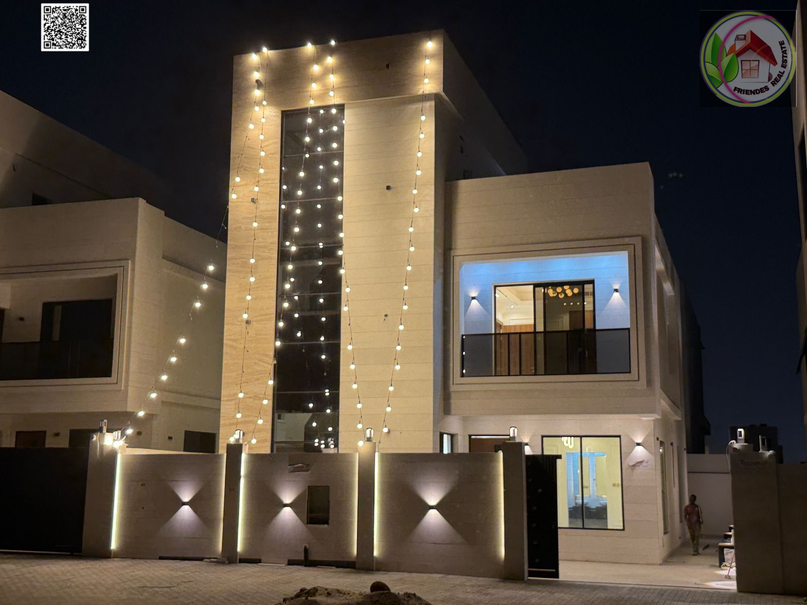 A distinctive two-story villa with a roof for sale – Al Helio 2 area, Ajman. Includes air conditioners, registration and ownership fees, and freehold