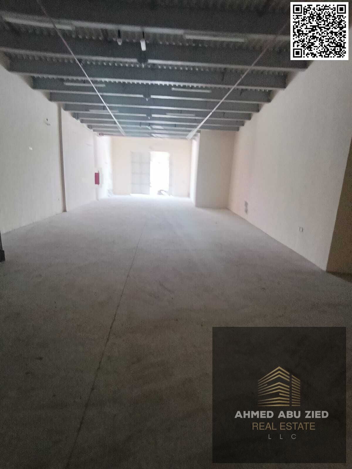 Warehouse for annual rent in Al Jurf Industrial | Prime location on a main road near key access routes | Ready space with built‑in scale and essential