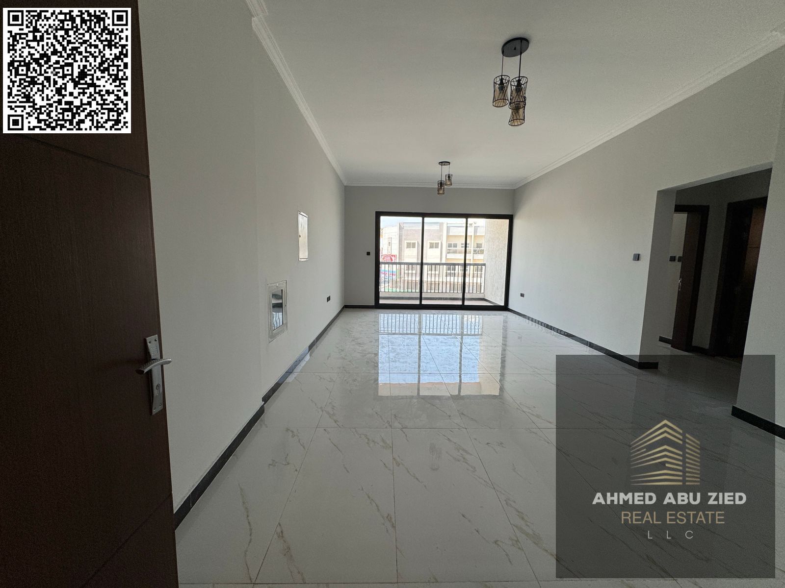 For annual rent in Ajman, a new building offers a two-bedroom apartment with a living room, three bathrooms, a balcony with an open view, spacious liv