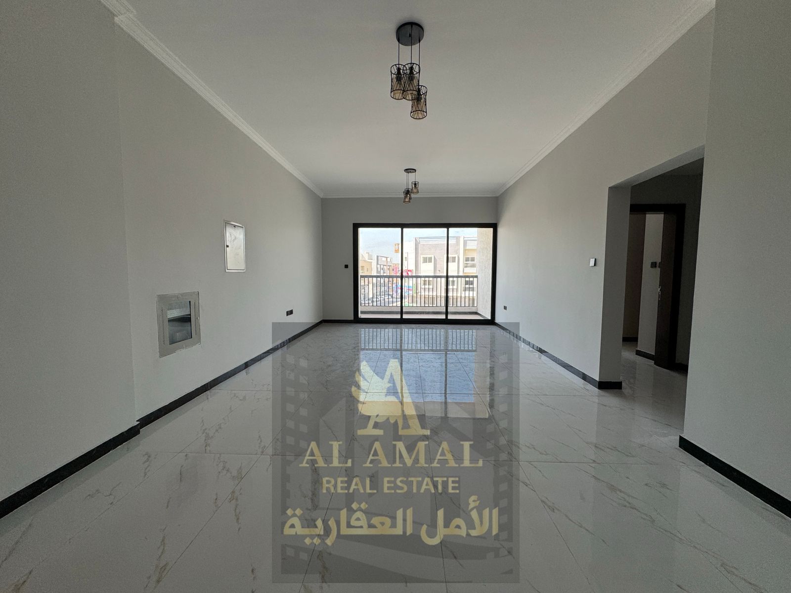 Luxury 2-bedroom apartment with living room for annual rent, first tenant, central air conditioning, balcony, large kitchen, and built-in wardrobes, l