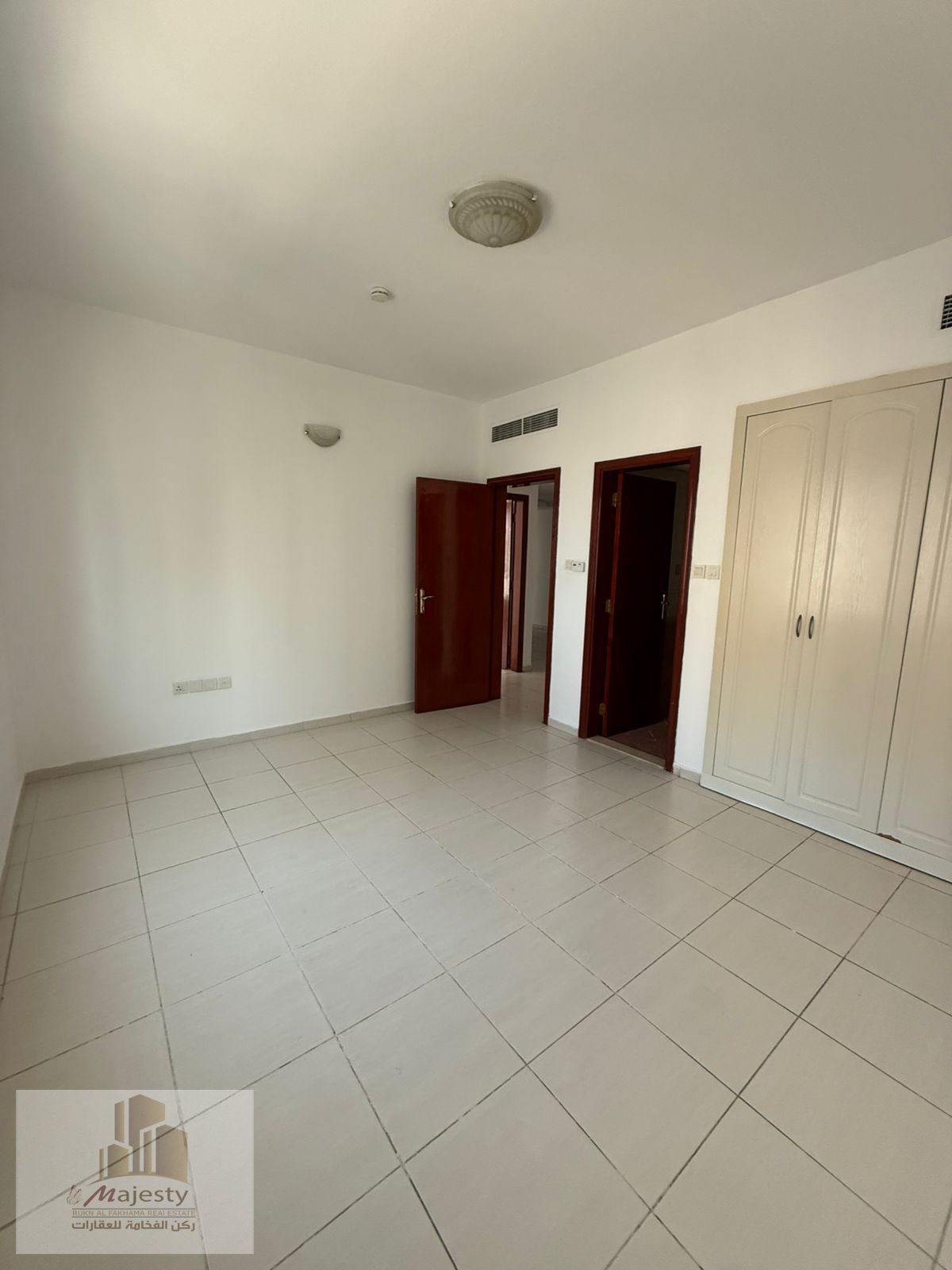 Two-bedroom apartment with a living room, including a master bedroom with built-in wardrobes, balcony, and two bathrooms, available for rent in Al Taa