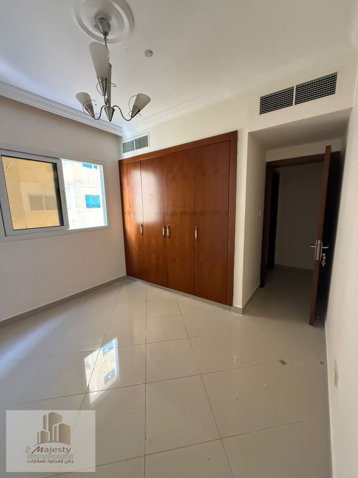 One-bedroom apartment with a living room, balcony, and built-in wardrobes is available for rent in Sharjah, Al Taawun area.