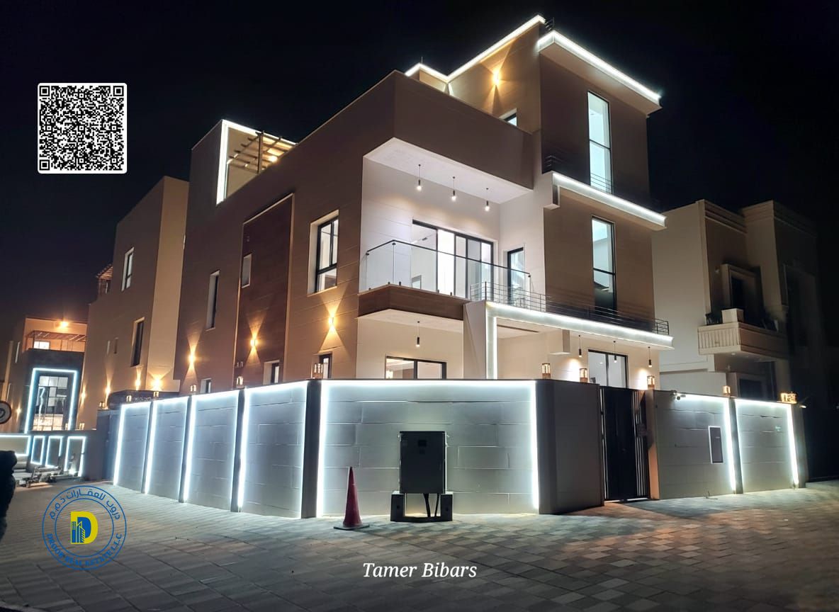 For sale: Modern 5-bedroom villa with a roof terrace, including registration fees, in Al Helio 2, Ajman. Freehold ownership . Bank financing .