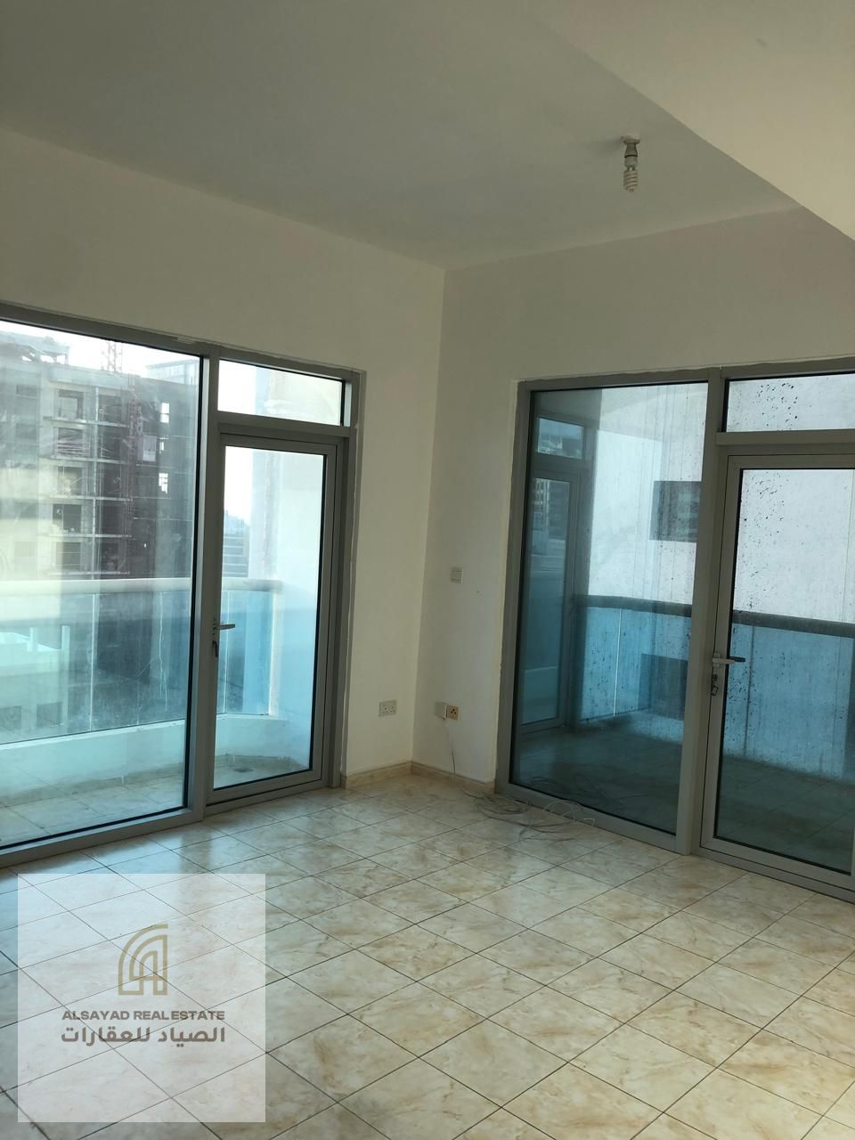 Two-bedroom apartment with a living room in Al Majaz 3, close to all services, with on-site amenities including a gym and swimming pool.