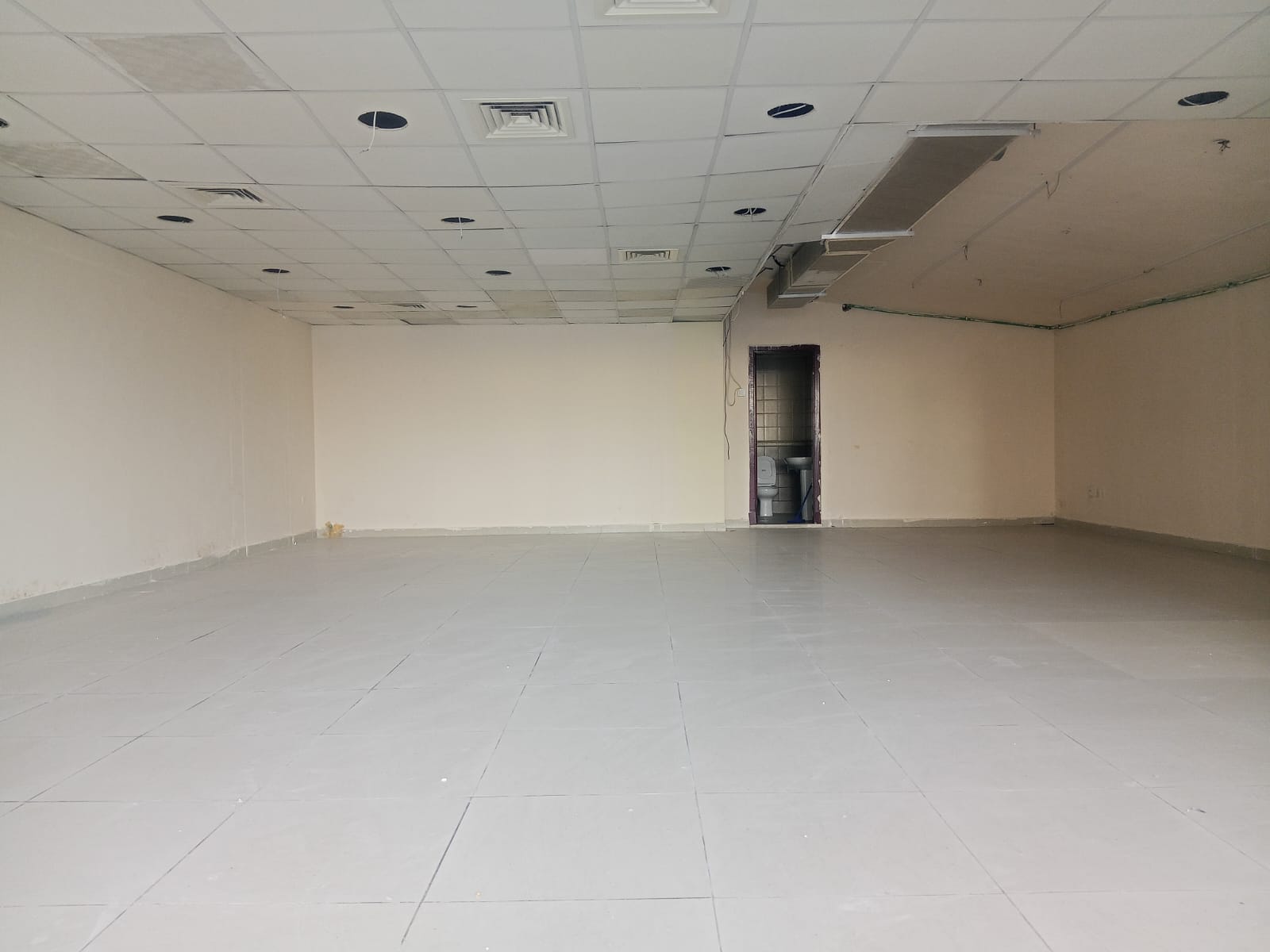 Spacious commercial shop for rent in Al Majaz 3 opposite the Corniche, suitable for most activities except barber shop, AED 100,000 in 4 cheques.