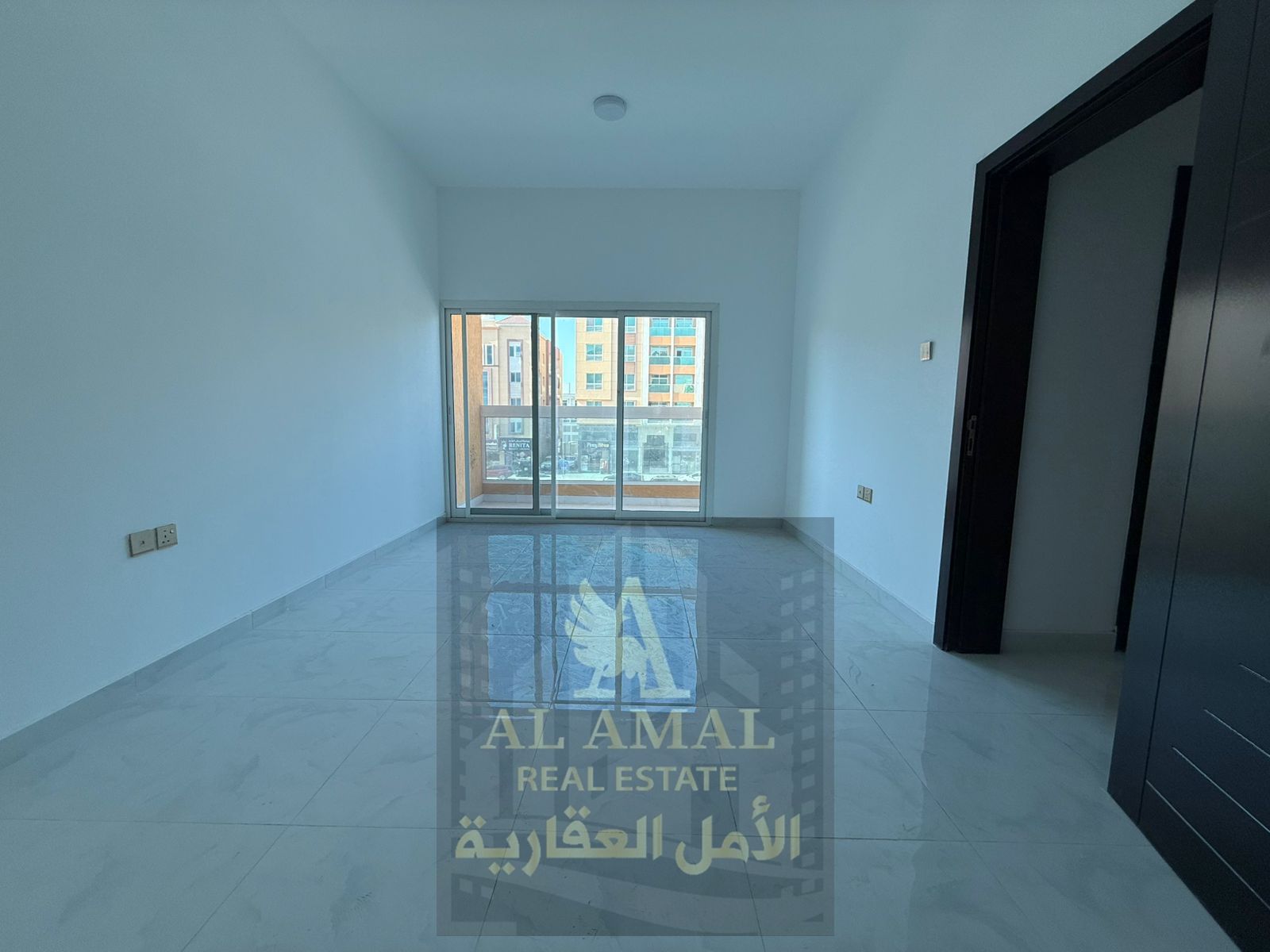 2BR hall, first tenant, Al Mowaihat 3.1 month free, 2 master rooms, 3 baths, balcony, central AC, easy Dubai exit.