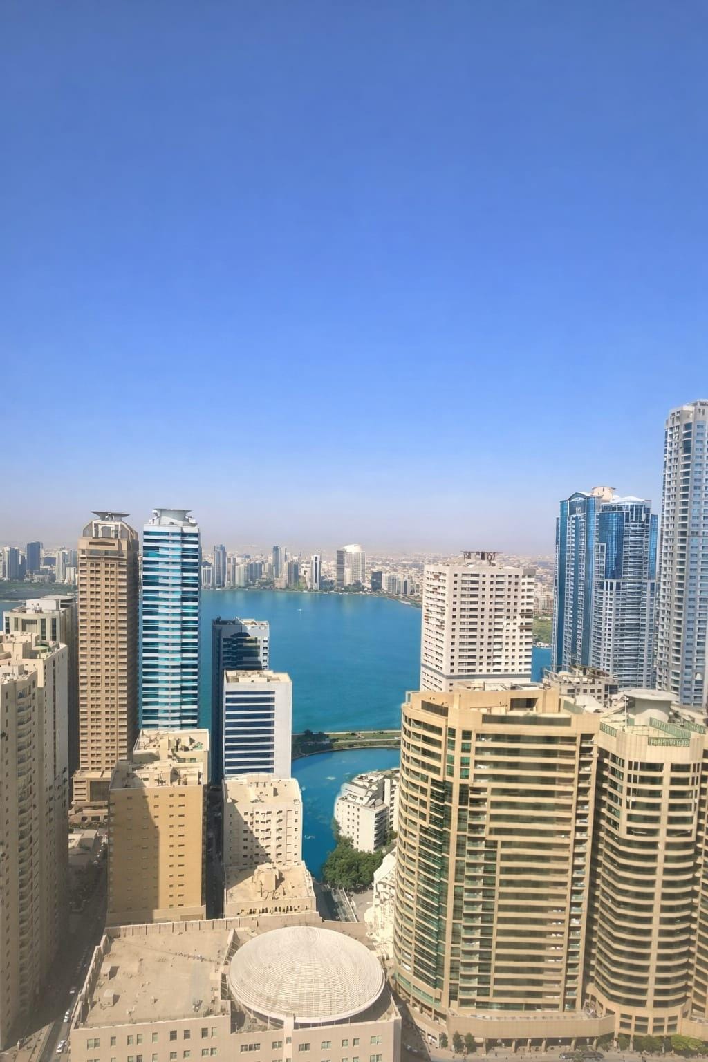 Apartment for sale in Al Khan on main road, 1200 sqft, 2 master bedrooms, 3 bathrooms, open view, private parking.