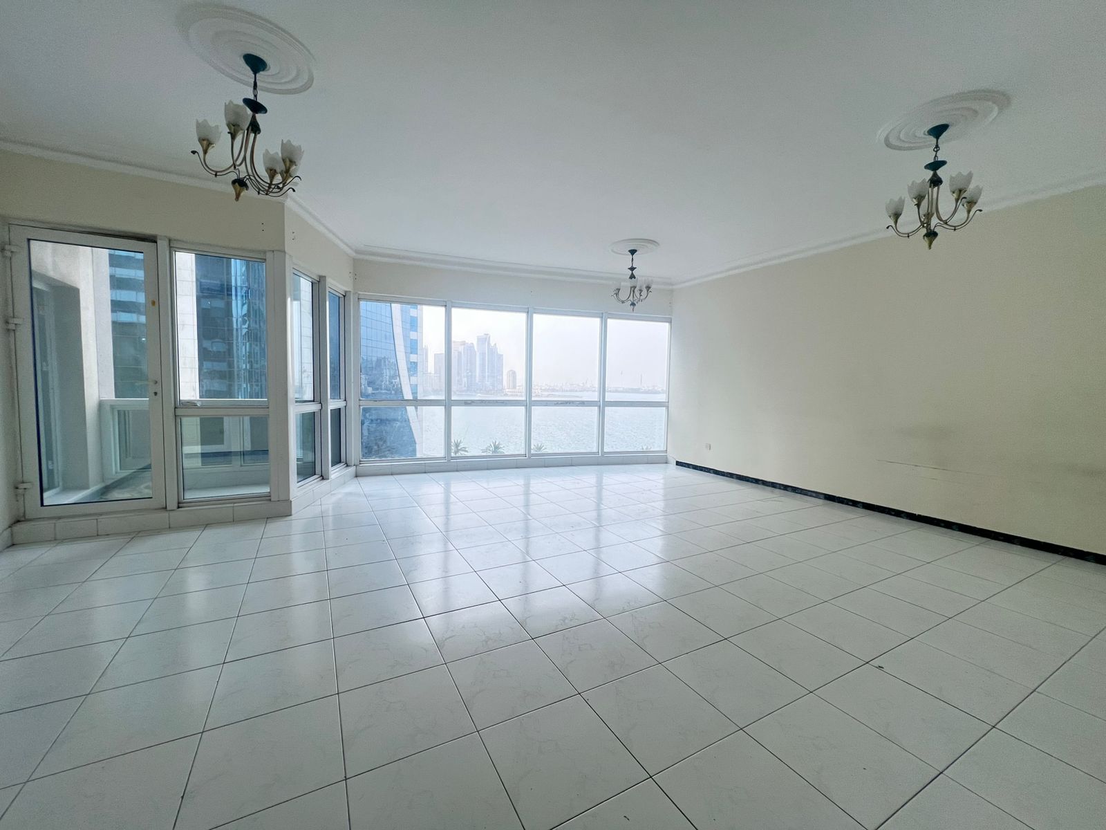 Balcony with a direct sea view overlooking Al Khan Lake Corniche, free air conditioning, and free gym & pool | Spacious layout, close to Dubai Exit