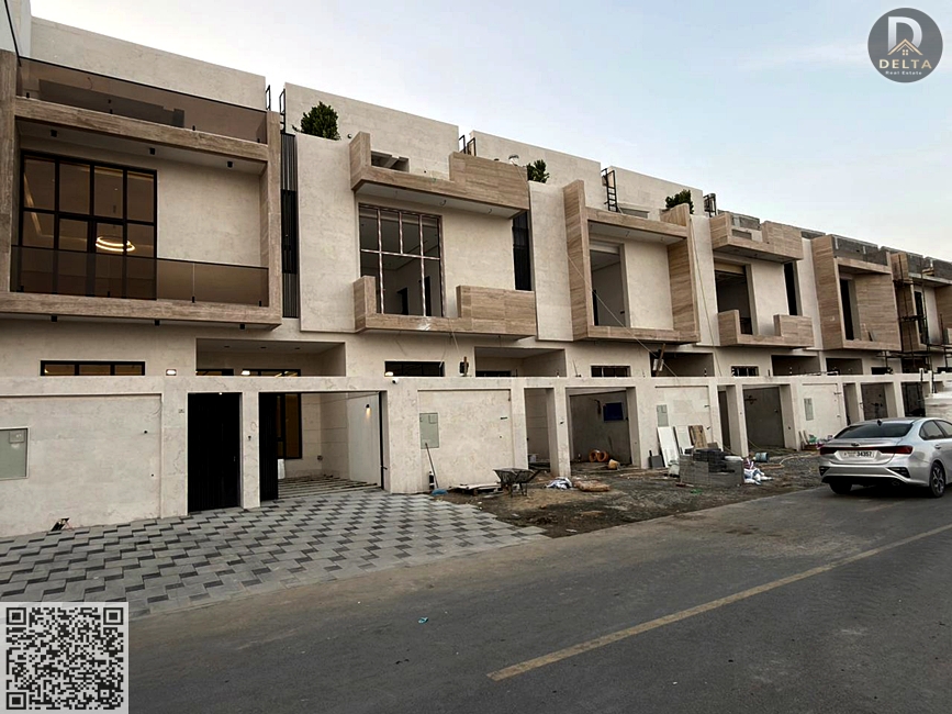 For sale: a modern townhouse villa in the Al Yasmin area. The price includes registration fees. It features a glass facade and a setback in front of t