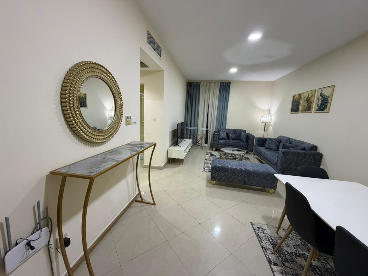 Furnished one-bedroom apartment with living room for rent in **Al Taawun**, 2 bathrooms, clean and ready to move in, close to services.
