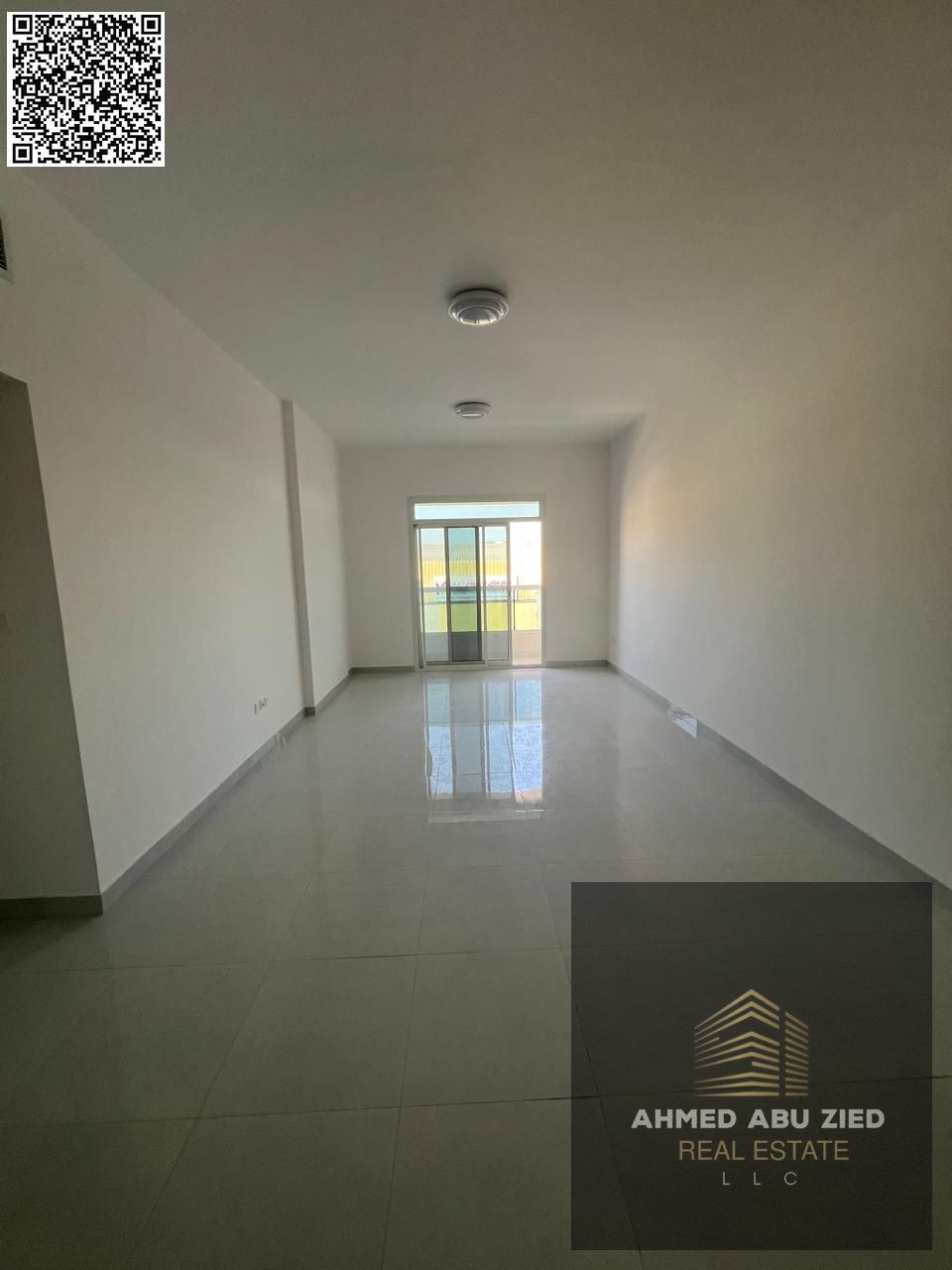 For annual rent in Ajman, a new building offers a two-bedroom apartment with a living room, three bathrooms, a balcony with an open view, spacious lay