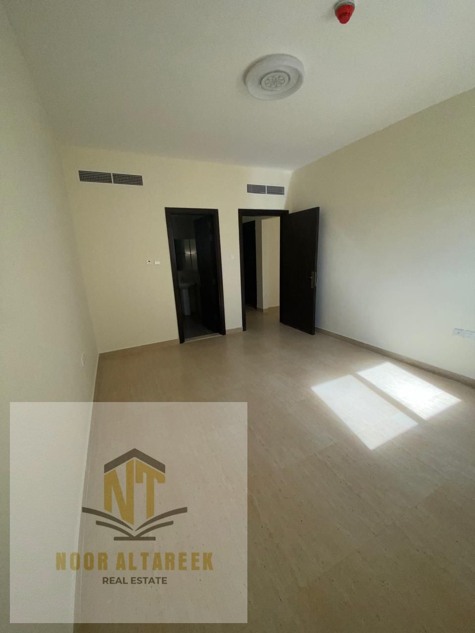 Professional and attractive ad: Apartment for annual rent in Al Musalla, Sharjah, featuring **1 bedroom and a spacious living room**, a **separate ki