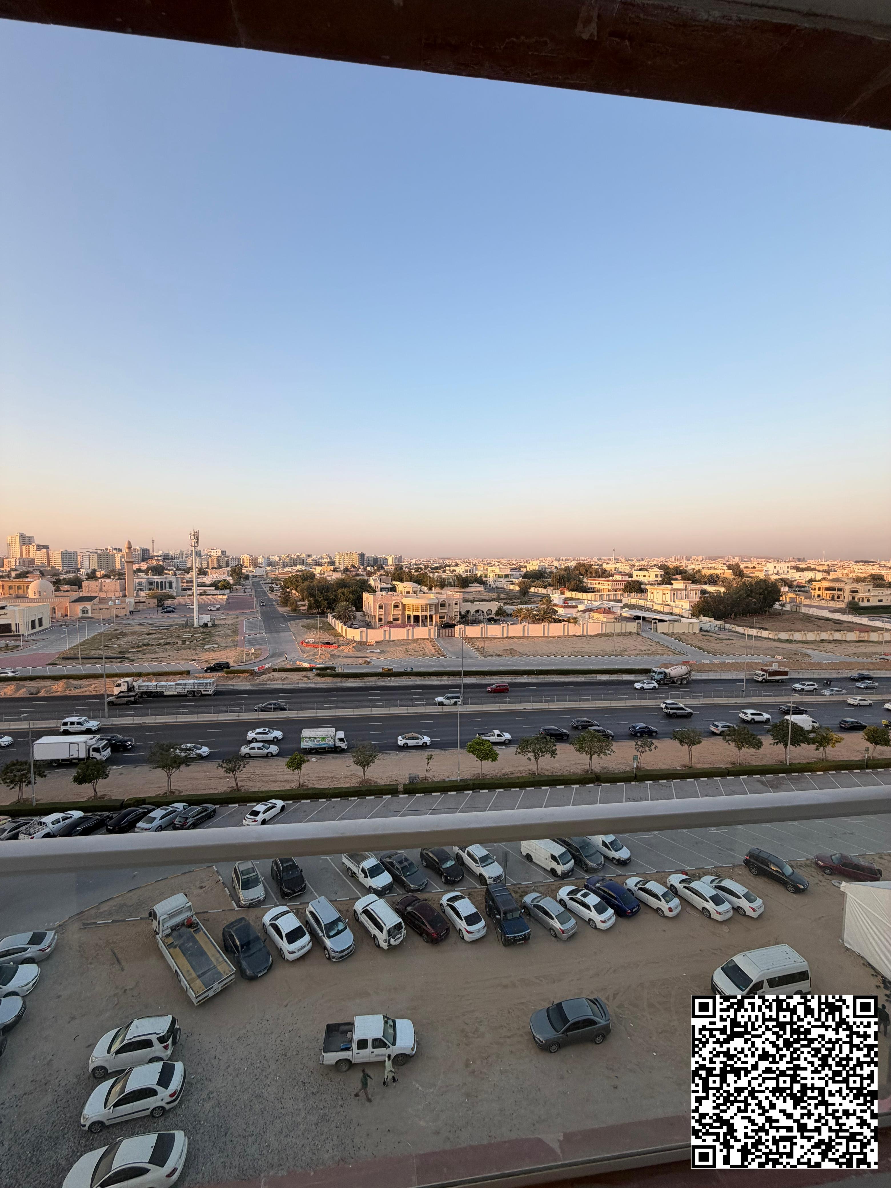 Two-bedroom apartment with a living room and an open view overlooking Sheikh Khalifa Street.