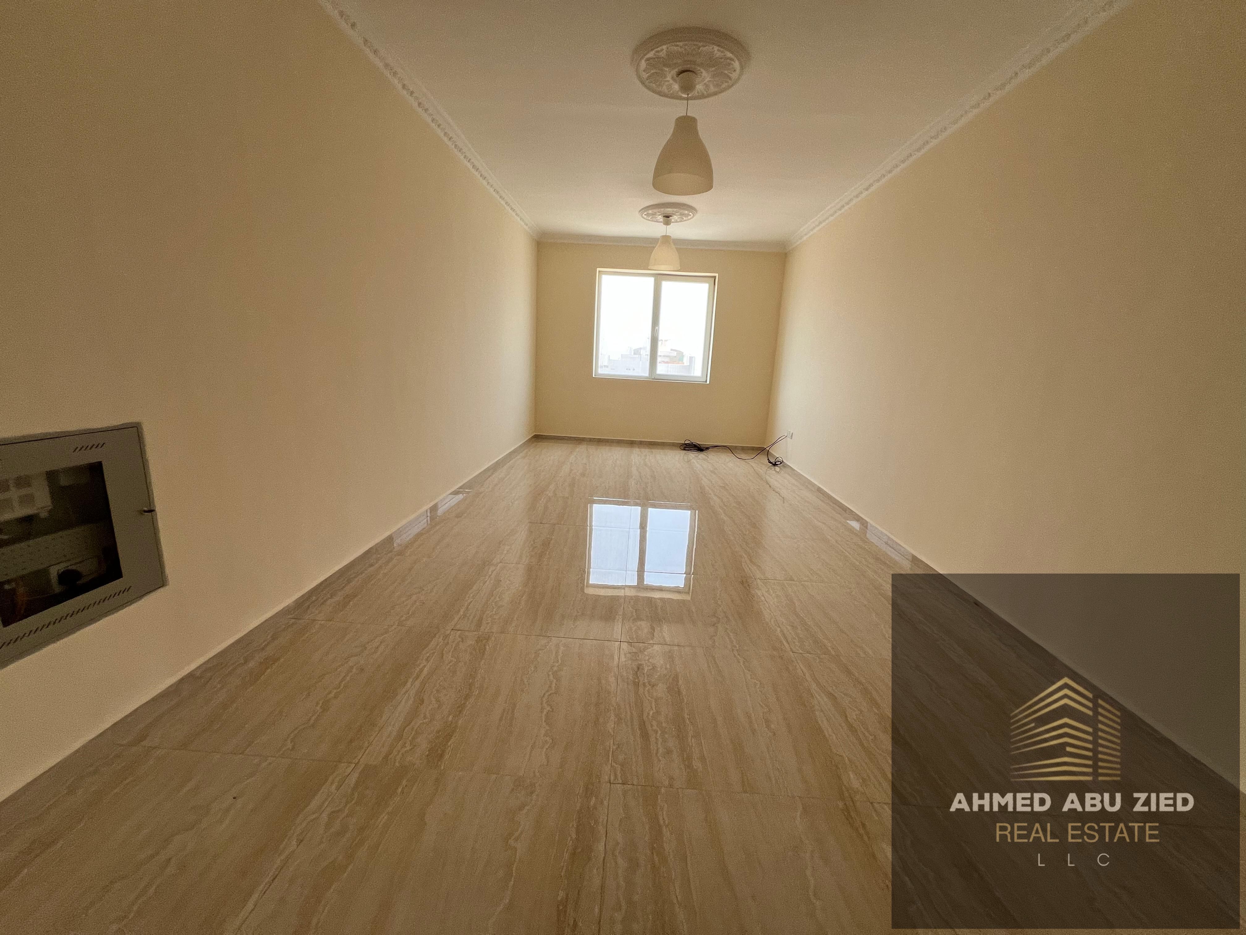 Two-bedroom apartment with living room for annual rent in Al Nuaimiya 3, free parking, 2 bathrooms, central AC, balcony, prime location