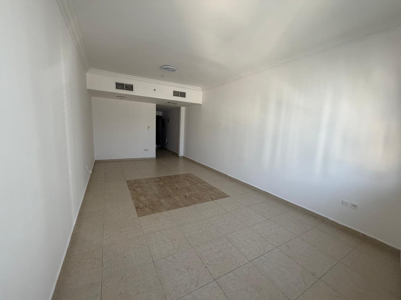 1BR + living room in Al Khan with 2 baths, balcony, free parking. Rent AED 48,000/year, 4 or 6 payments, 5% cash deposit, ready to move in.