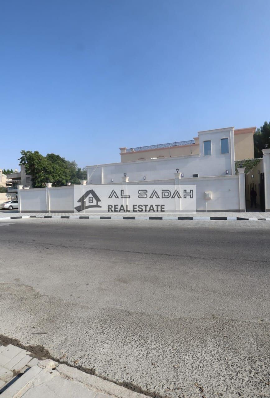 Villa for sale in Al Mansoura, Sharjah. Single-story villa on a corner lot with two street frontages. Area: 5086 sq ft. Features 6 master bedrooms, 2 living rooms, and an external majlis. Prime location, very close to the main road and mosque. Asking pric