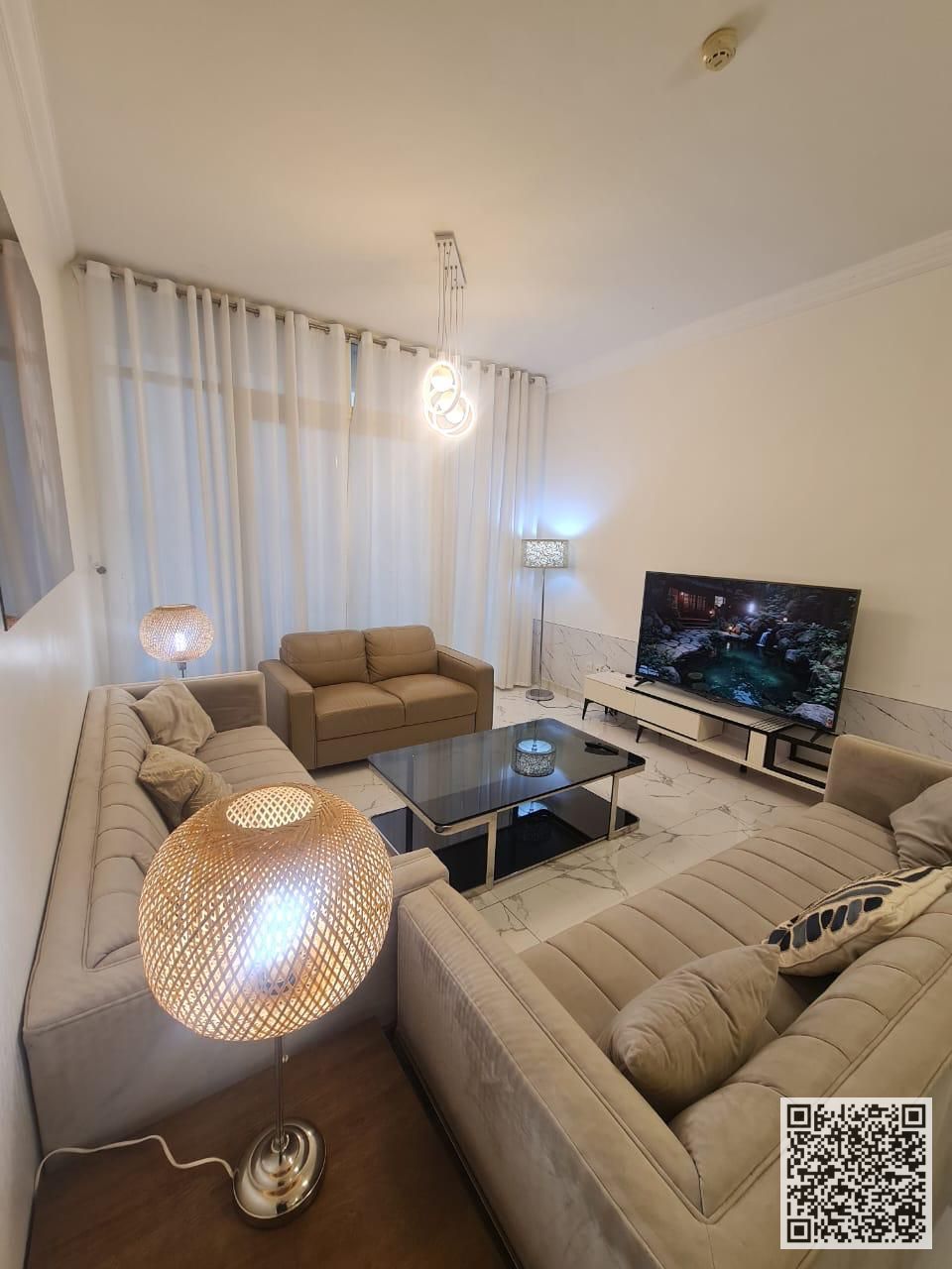 Luxurious and elegant three-bedroom apartment with a living room, fully furnished with brand new, high-end furniture, in a prime location with a gym,
