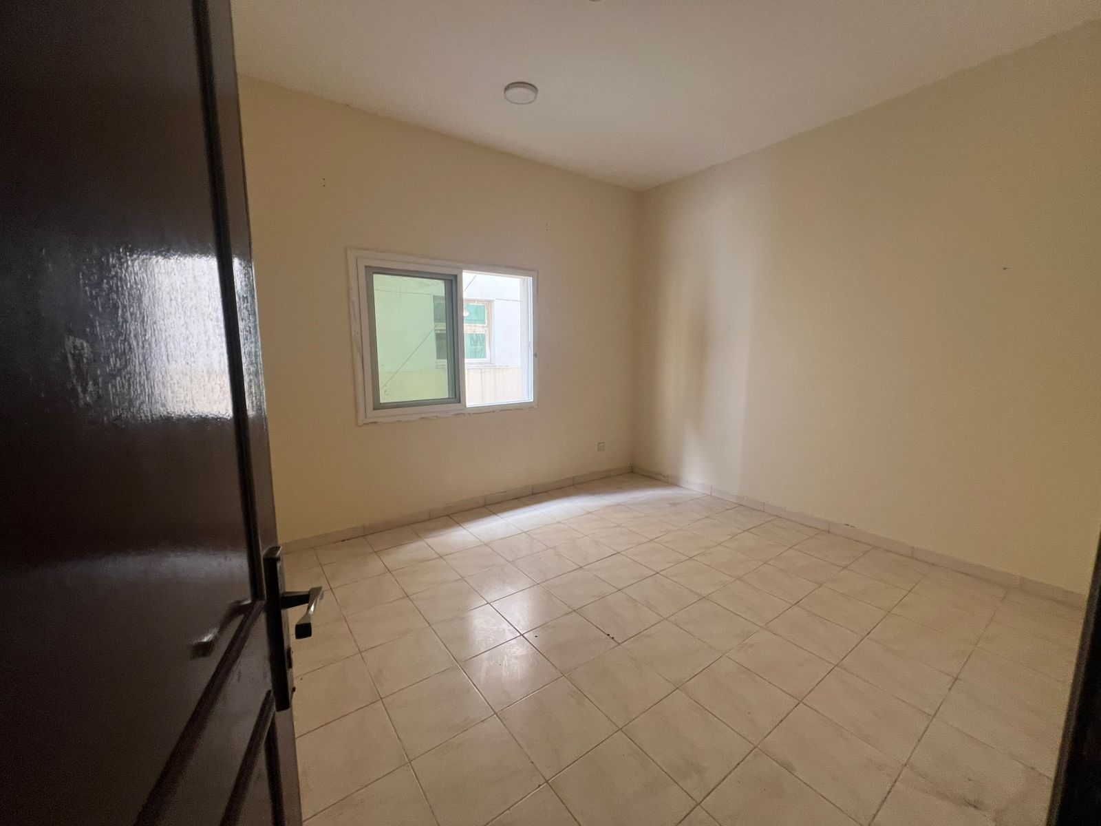 For rent 1BR + living room in , rent AED 26,000/year, 4 cheques, deposit AED 5,000, ready to move in.