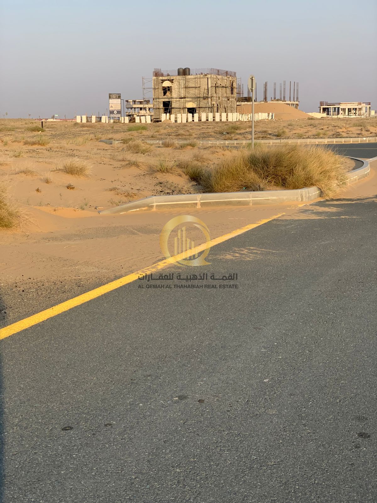 Investment opportunity in Rawdat Al Qurt: Prime commercial land for sale on a 24-meter wide street, measuring 6595 square feet.