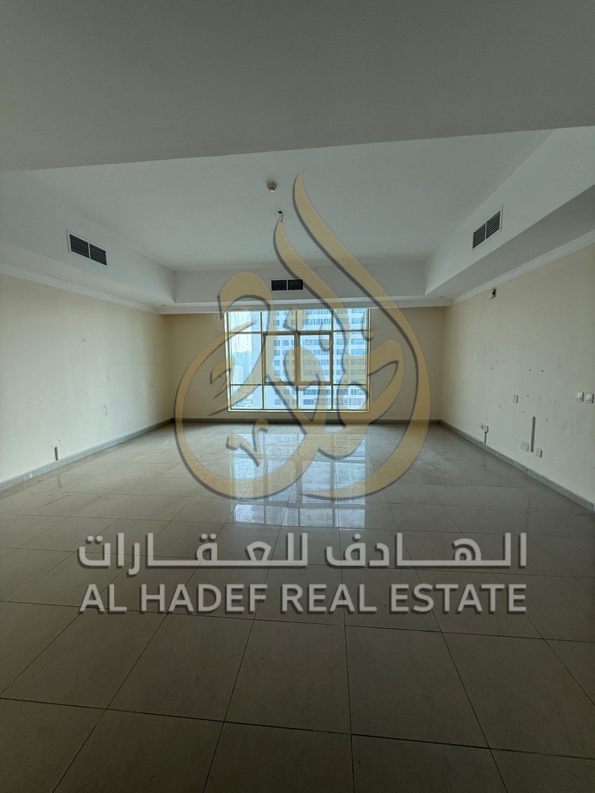 For rent in Al Taawun: a two-bedroom apartment with a living room and two balconies - near D2D - free air conditioning - free maintenance - free gym