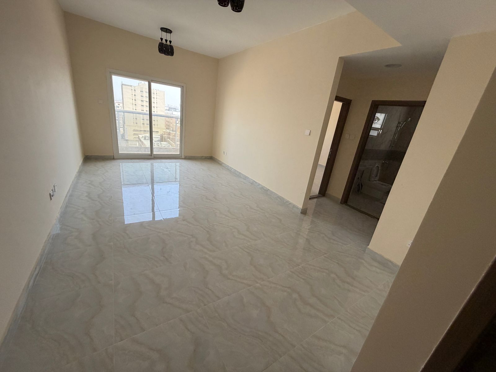 One bedroom and living room, first occupancy, in Al Jurf 3, near the Chinese Market and Al Qabail Discounts, on Mohammed Bin Zayed Exit. Central air c