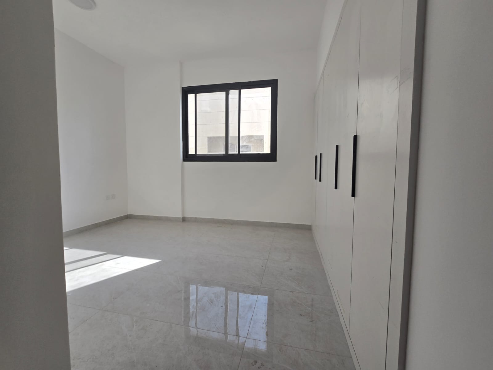 Beautiful two-bedroom apartment with a living room in Ajman, Al Hamidiya area, with a maid's room and three bathrooms.