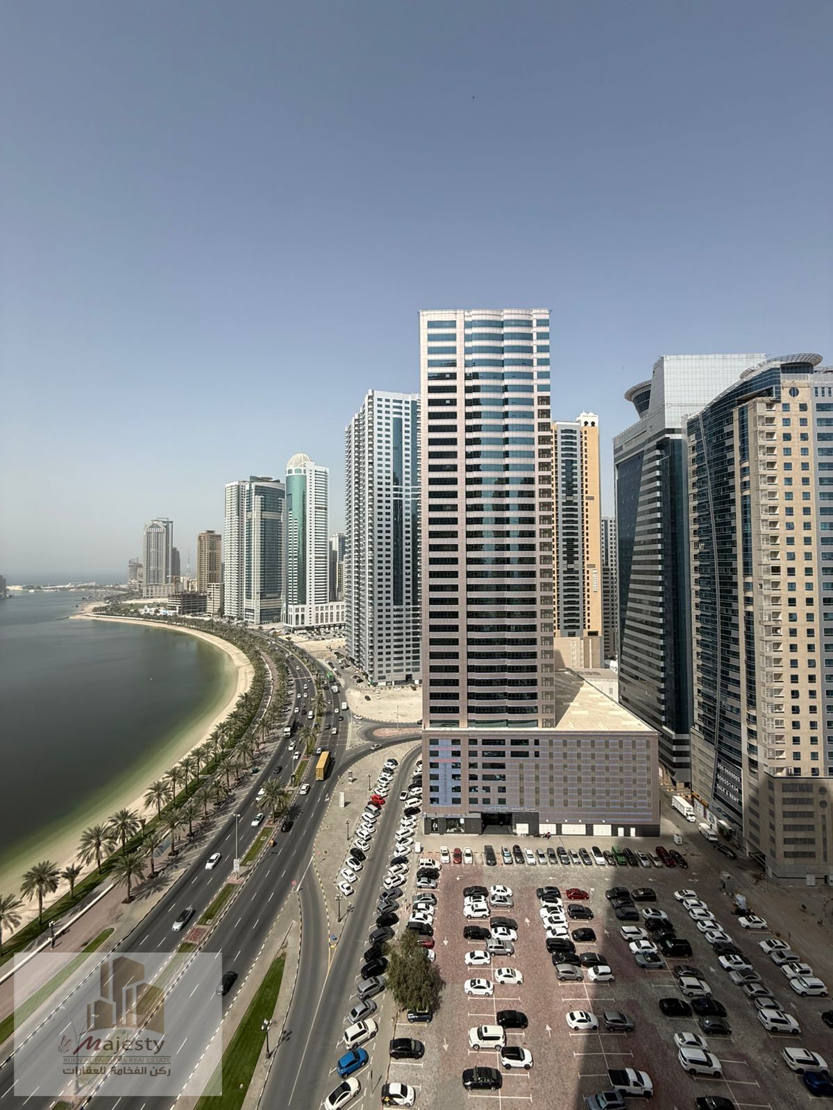 A two-bedroom apartment with a large living room, balcony overlooking Al Khan Lake, and a laundry room is available for rent in Al Khan area, Sharjah.