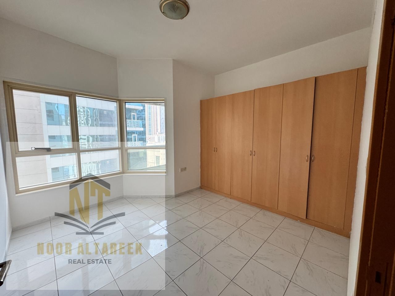 Apartment for rent in Al Taawun featuring two bedrooms, including a master bedroom, three bathrooms, a spacious living room, and a balcony, providing