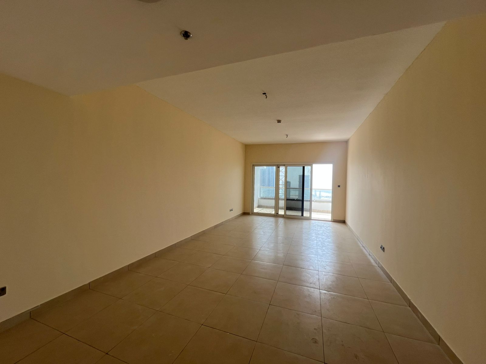The most luxurious two-bedroom apartment with living room in Sharjah, featuring parking, gym, and swimming pool, built-in wardrobes, master maid’s roo