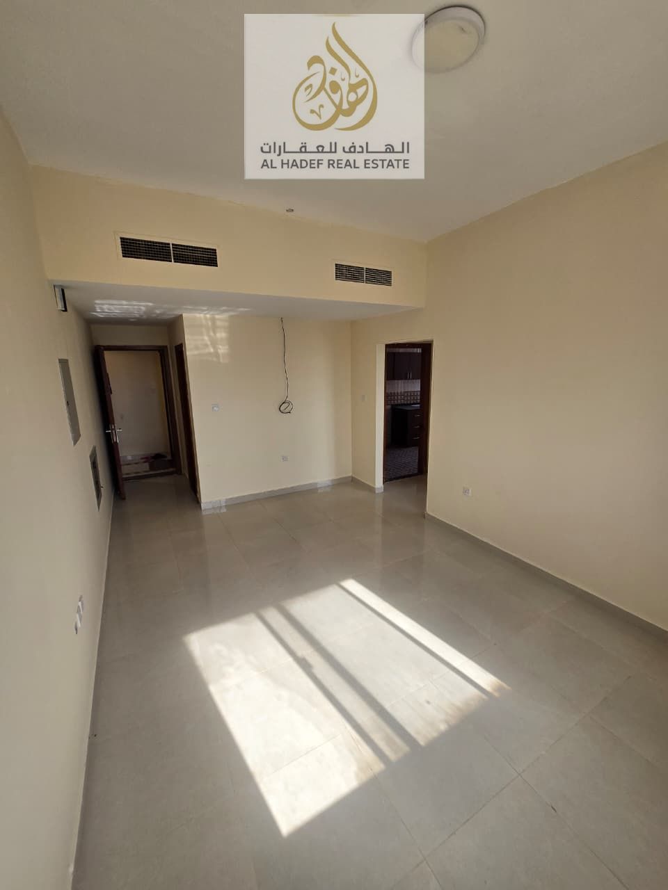 One-bedroom apartment with a living room, two bathrooms, balcony, and a large kitchen in a prime location in Al Rawda.