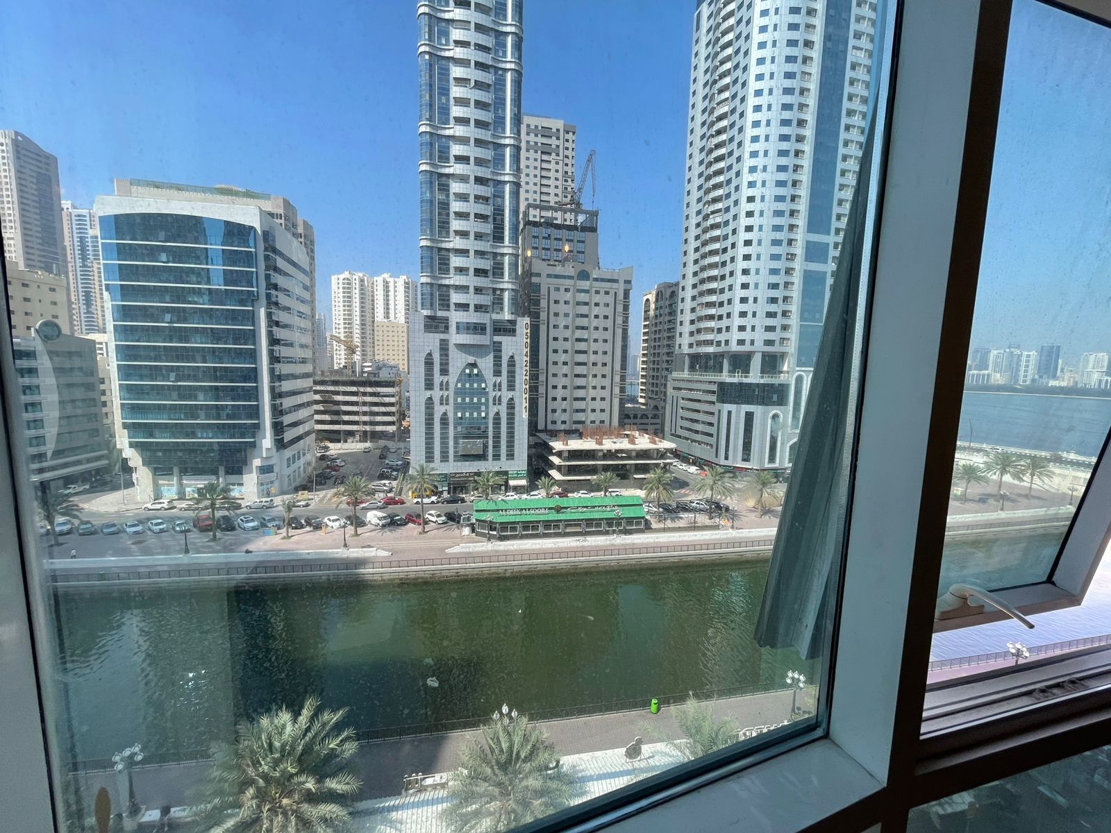 Free gym, swimming pool, and parking with balcony in a prime, lively location close to cafes, shops, and near the Dubai exit with easy access.