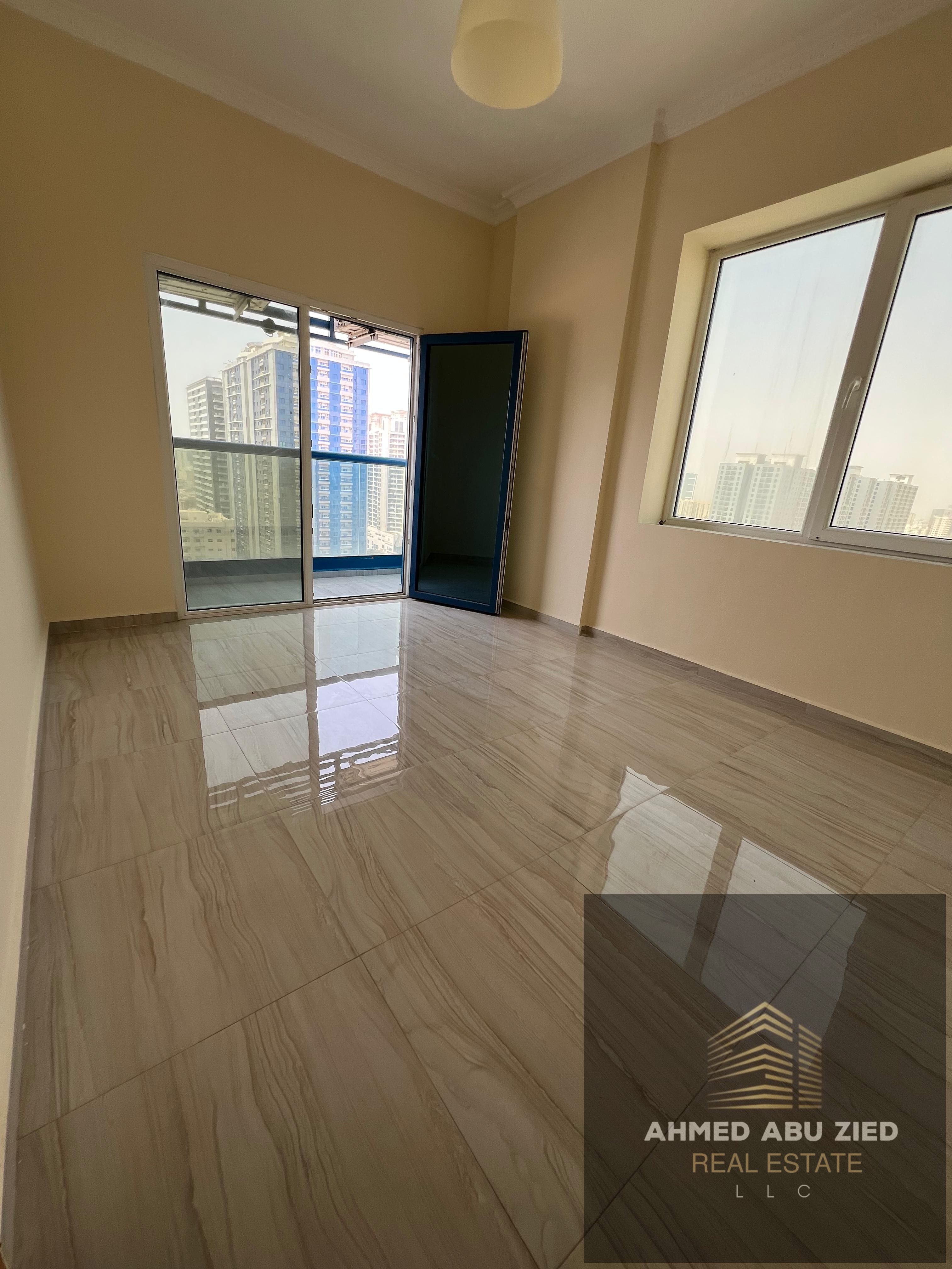 2-BR apartment with living room for annual rent in Al-Naeemia 3, Ajman, 2 baths, spacious living area, free parking, 4 installments, security cheque,