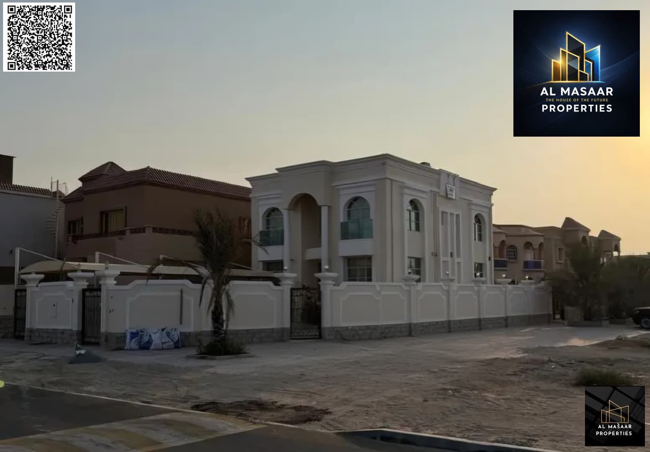 A corner plot for sale in Al Muwaihat 1, located on two streets and the main road, with an area of 5000 sq ft. The price includes electricity, water