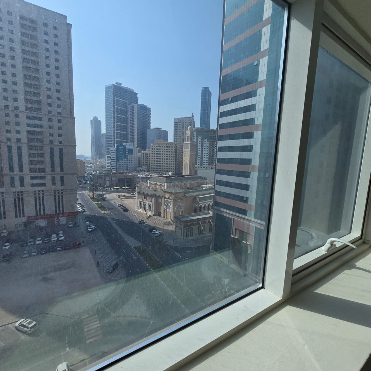**Spacious apartment with free parking, central A/C, built-in wardrobes, balcony with open view, prime location, and flexible payment options. **