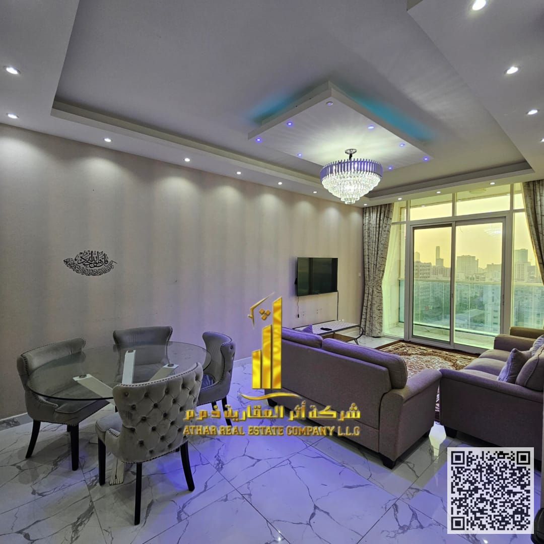 With an open view, a fully furnished 2-bedroom apartment with a living room for monthly rent in Ajman - Al Rashidiya. with gym, pool, and parking.