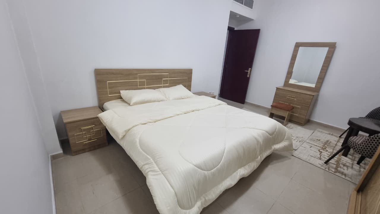 Furnished one-bedroom apartment with living room, first tenant, in Al Khan 3 for monthly rent. Brand-new furniture, central AC, prime location