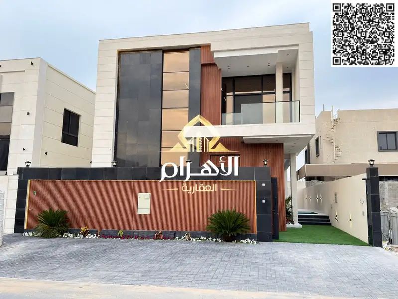 Luxury villa for sale in Al Bahia area, featuring two floors and a rooftop terrace. Modern design, spacious living areas, reception halls,